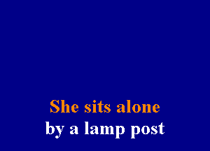 She sits alone
by a lamp post