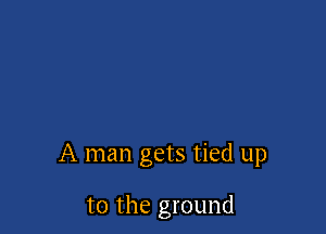 A man gets tied up

to the ground