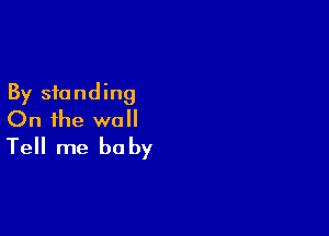 By standing

On the wall
Tell me baby